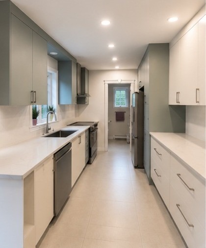 Galley kitchen with sage green and white cabinets in Montreal