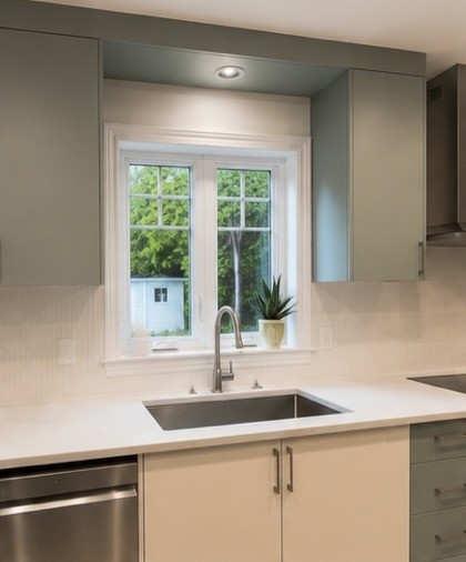 Kitchen sink wall with white cabinets and quartz countertop