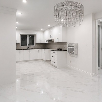 White custom kitchen with chandelier in Greater Montreal