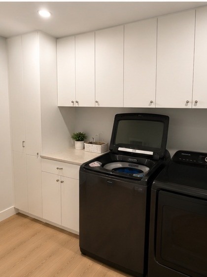 Laundry room with white wall cabinets
